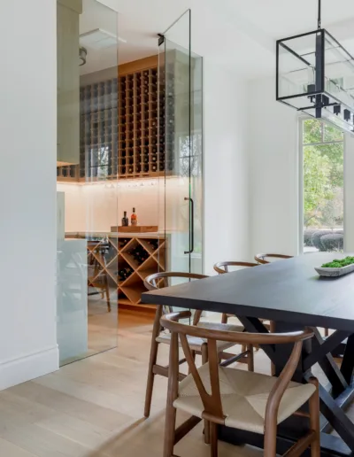 A modern dining room with a wine cellar.