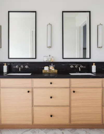 A bathroom with two sinks and two mirrors.