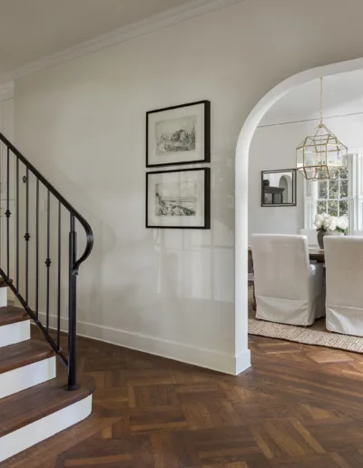An entryway with hardwood floors and a staircase.